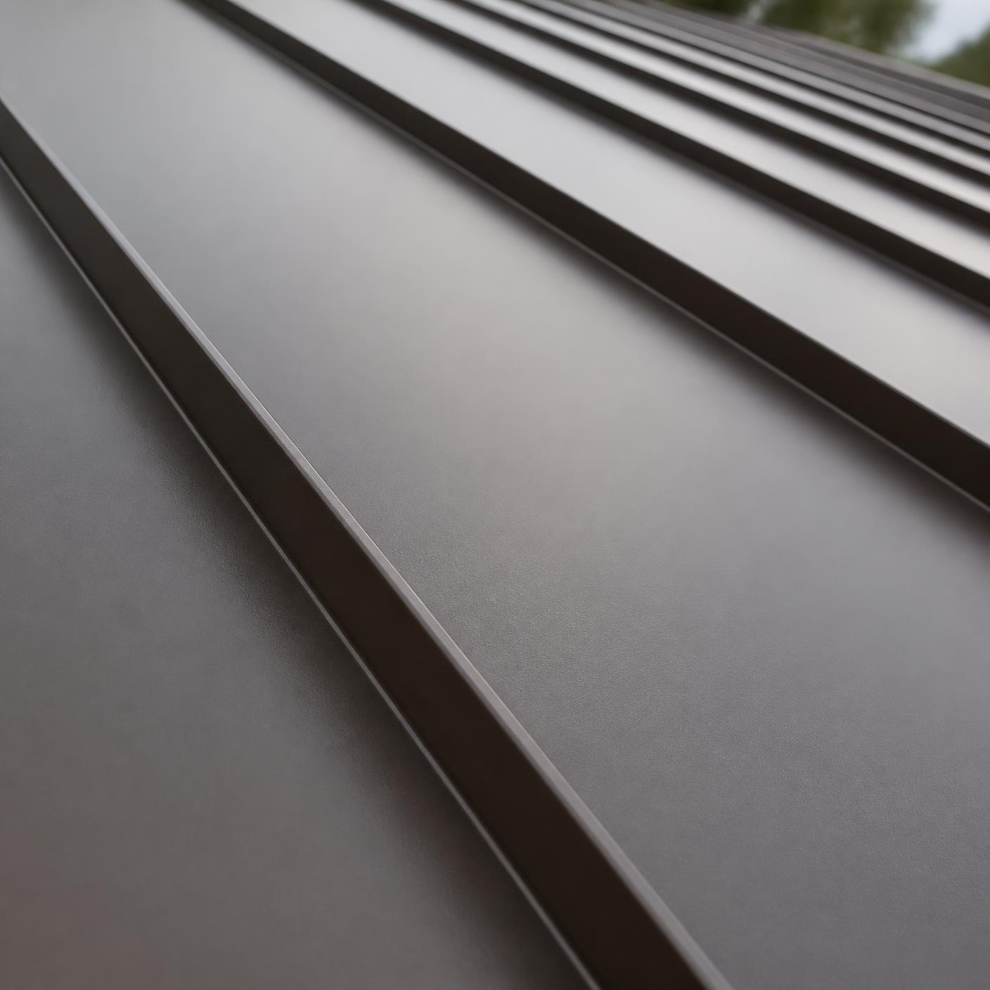 Close-up of raised seams on a dark bronze standing seam metal roof panel